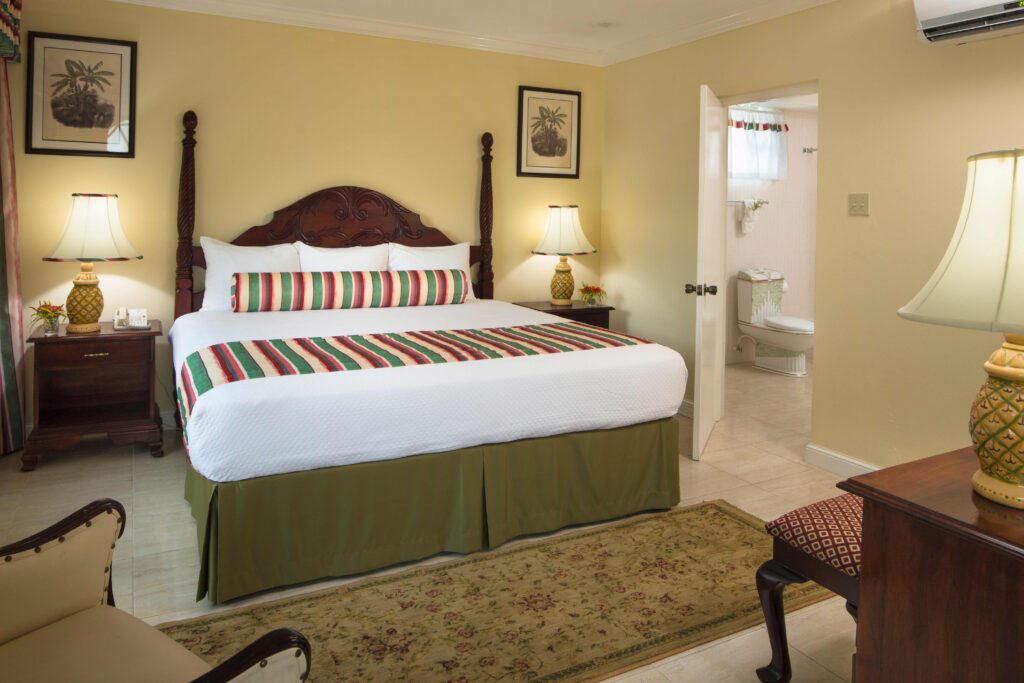 Standard Room with a mahogany four-poster king bed