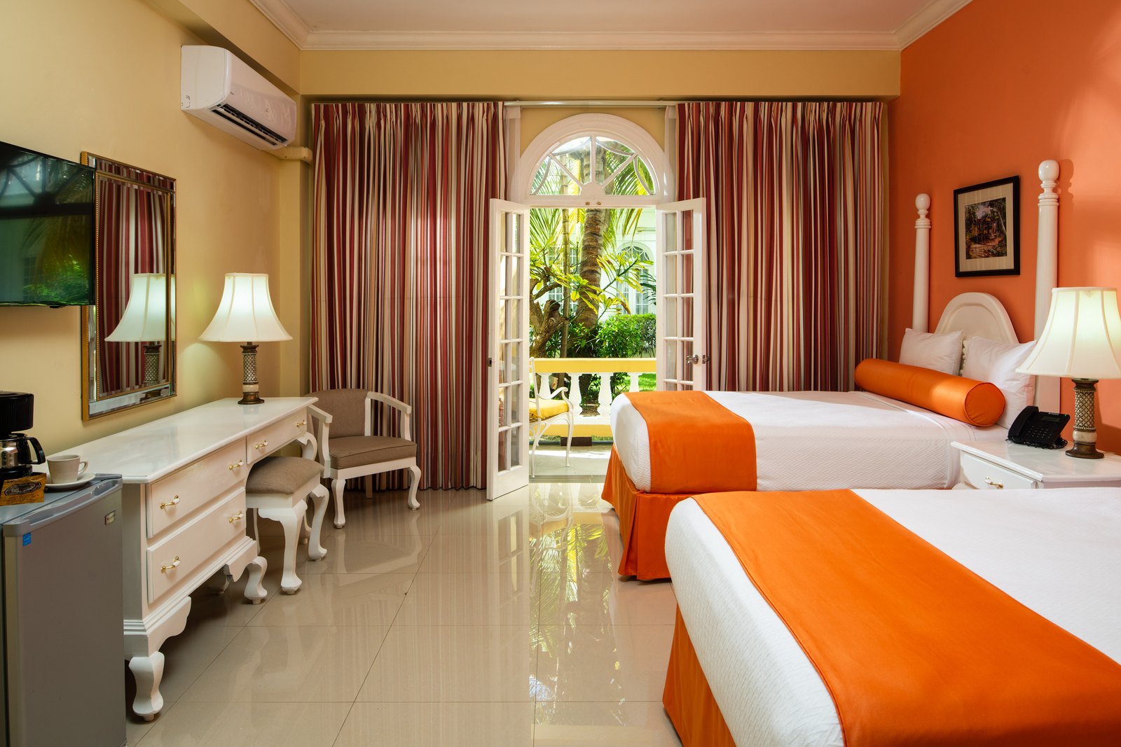 Deluxe Garden View room with two beds and a balcony over the gardens