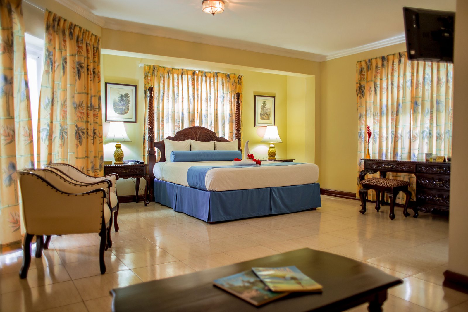 One Bedroom Ocean View Suite with arched doorway and king bed